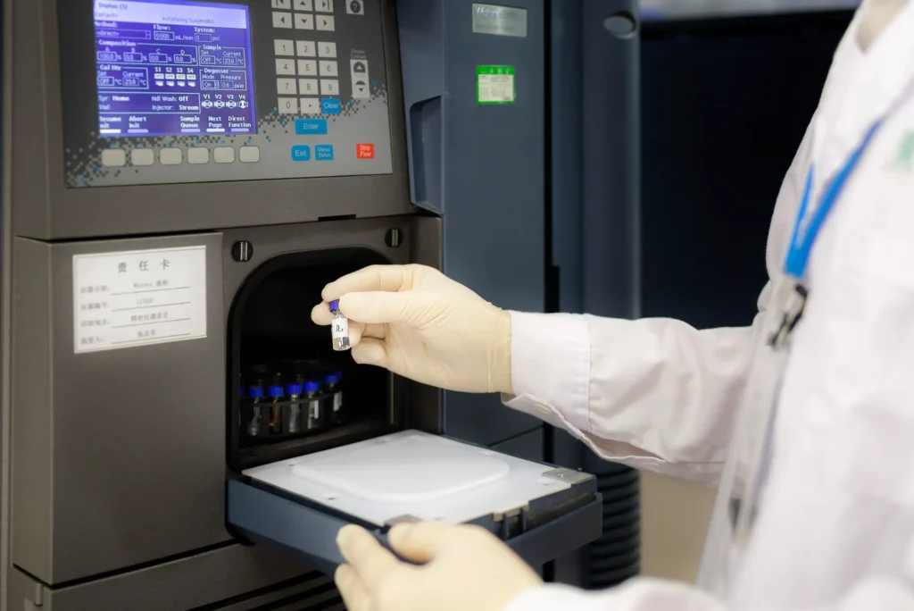 JYMedtech laboratory technician preparing a sample for HPLC analysis in pharmaceutical quality control