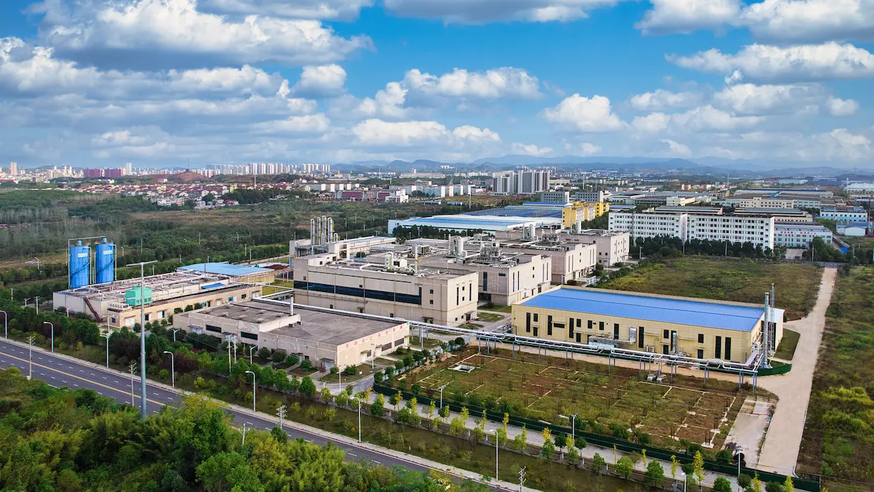 Aerial photo of JYMed’s Hubei JXBio manufacturing facility, featuring GMP buildings, green spaces, and industrial infrastructure across a 300-acre campus.