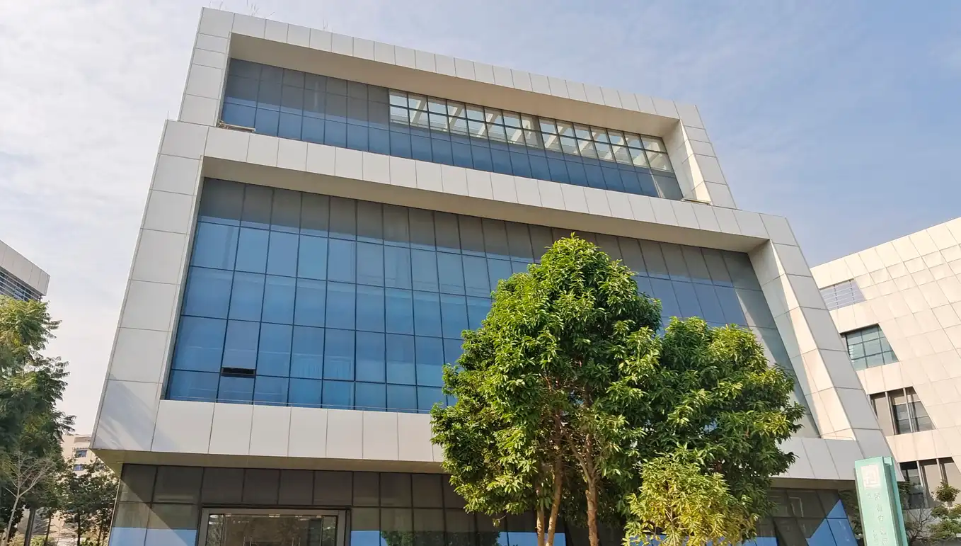 Modern Office Building at JYMedTech Shenzhen Facility Front view of JYMedTech’s modern Shenzhen facility with glass exterior and surrounding greenery