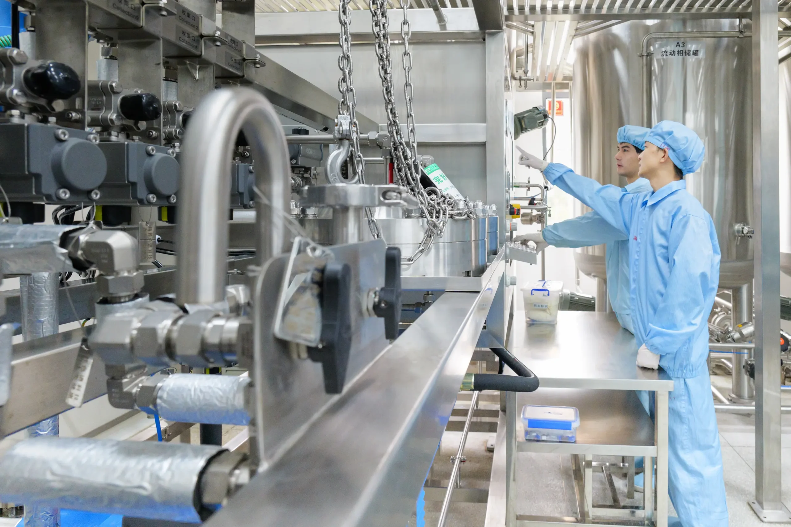 Sustainable Peptide Manufacturing Facility – Green Chemistry Pharma Production sustainable peptide manufacturing facility with technicians operating pharmaceutical reactor equipment