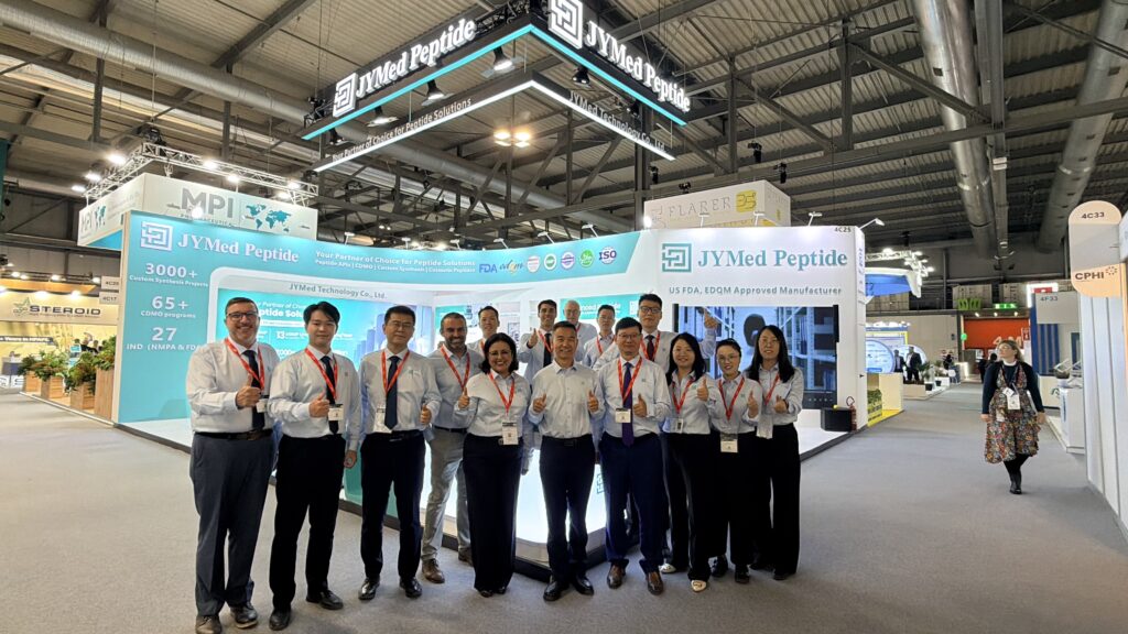 JYMed Peptide team members posing for a group photo in front of their exhibition booth at CPHI Milan 2026.